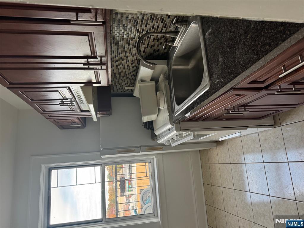 a kitchen that has a sink and a stove