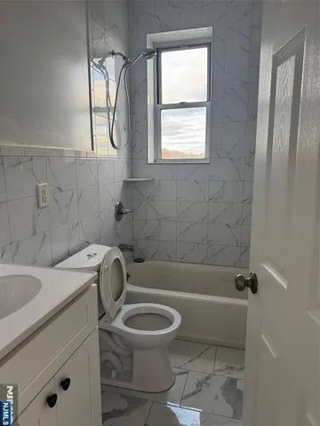 a bathroom with a sink a toilet and a bathtub