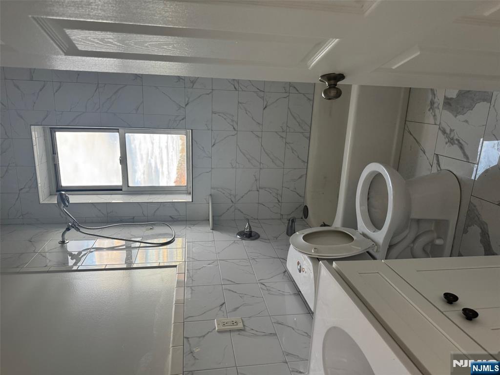 311 Queen Anne Road, Unit 46 Teaneck, NJ 07666 - Photo 4 of 6 a bathroom with a sink a toilet and a bathtub