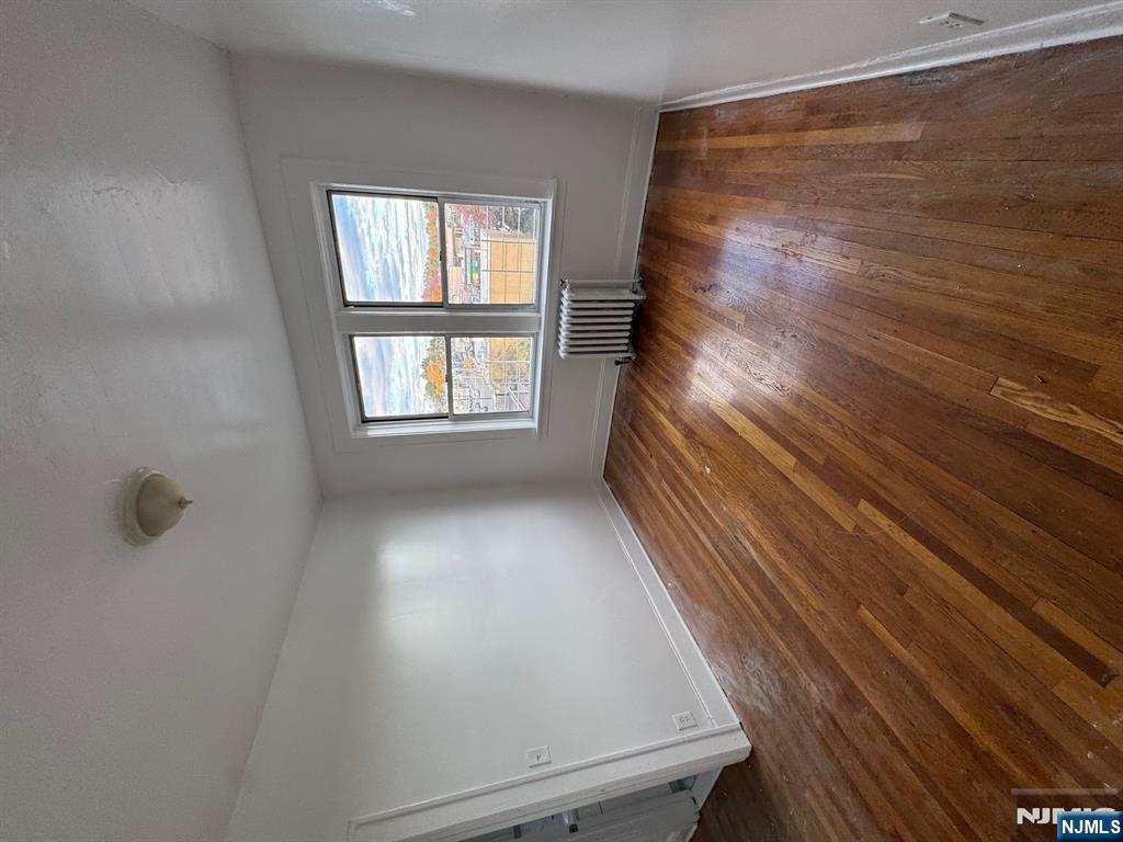 311 Queen Anne Road, Unit 46 Teaneck, NJ 07666 - Photo 6 of 6 an empty room with wooden floor and windows