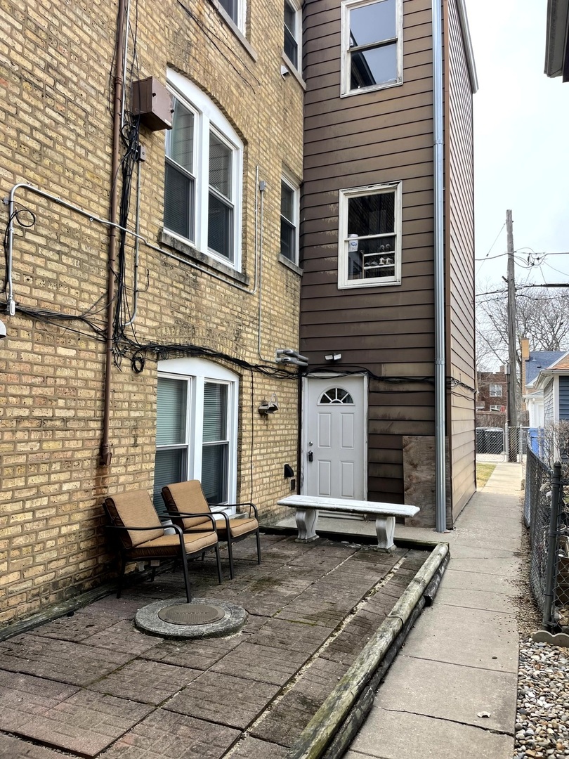 6010 West Seminole Street, Unit 2 Chicago, IL 60646 - Photo 14 of 14 a view of a patio with a table and chairs and ice snow