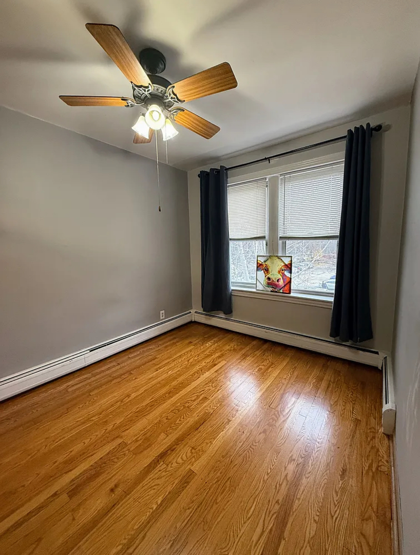 6010 West Seminole Street, Unit 2 Chicago, IL 60646 - Photo 4 of 14 wooden floor in an empty room with a window