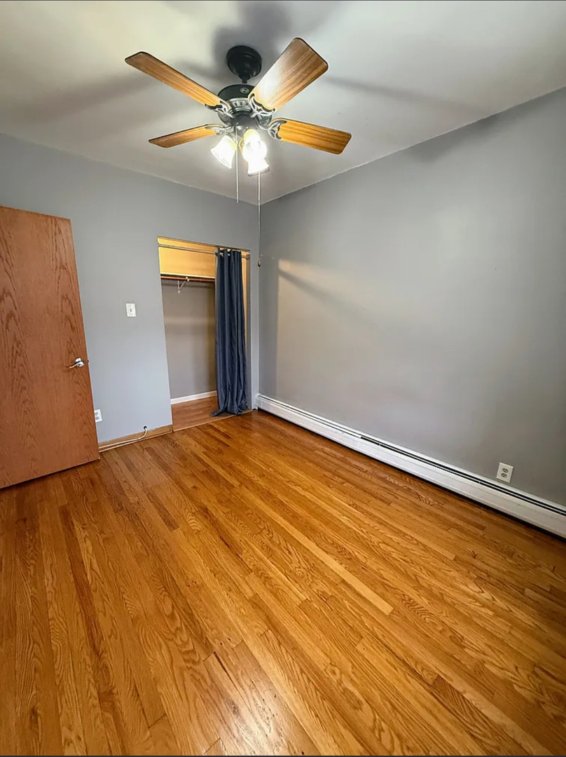 6010 West Seminole Street, Unit 2 Chicago, IL 60646 - Photo 6 of 14 a bedroom with a bed and a chandelier