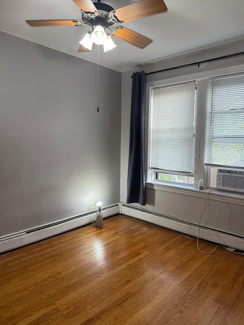 6010 West Seminole Street, Unit 2 Chicago, IL 60646 - Photo 10 of 14 wooden floor in an empty room with a window
