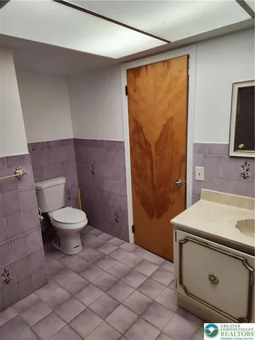 a bathroom with a sink a toilet and a shower