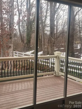 a view of a balcony with trees