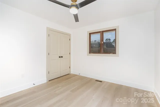 a bathroom with a sink mirror vanity and toilet