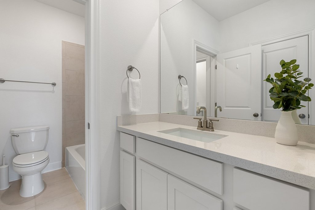 365 Pear Tree Lane Austin, TX 78737 - Photo 34 of 39 a bathroom with a granite countertop toilet sink and mirror