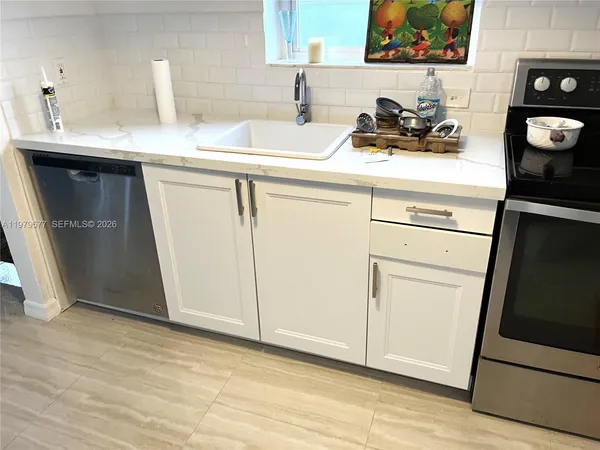 a kitchen with a sink and cabinets