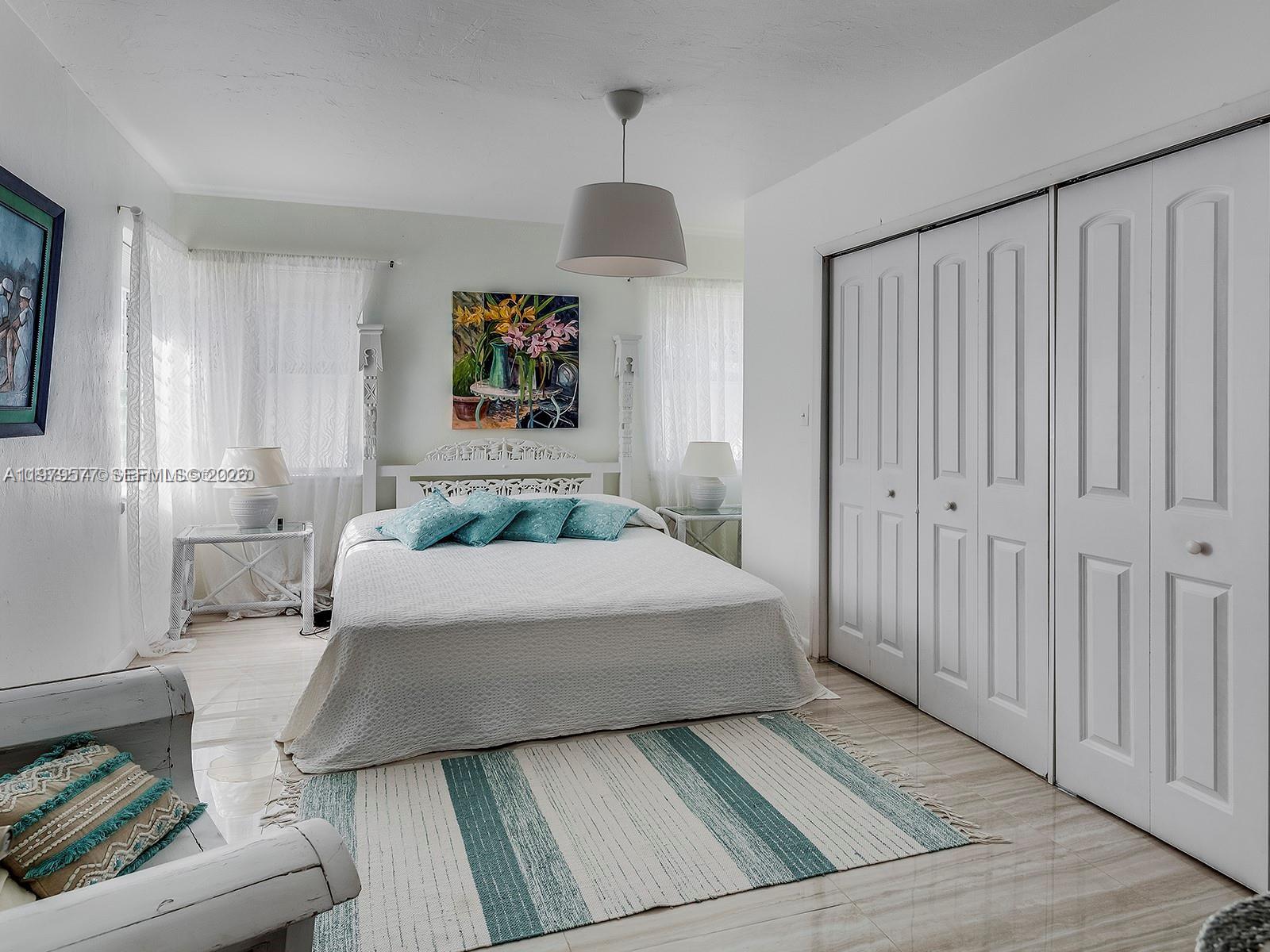 6910 Rue Notre Dame Miami Beach, FL 33141 - Photo 13 of 24 a bedroom with a bed and a window