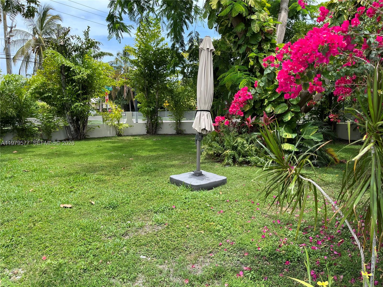6910 Rue Notre Dame Miami Beach, FL 33141 - Photo 15 of 24 a view of a garden with plants and large trees