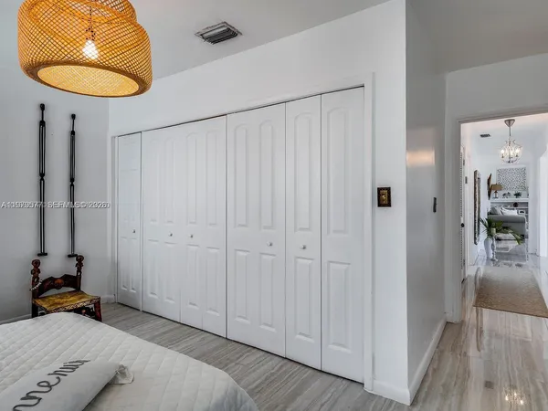 a bedroom with a bed and a chair