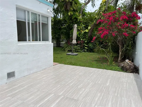 a view of flower garden with a bench