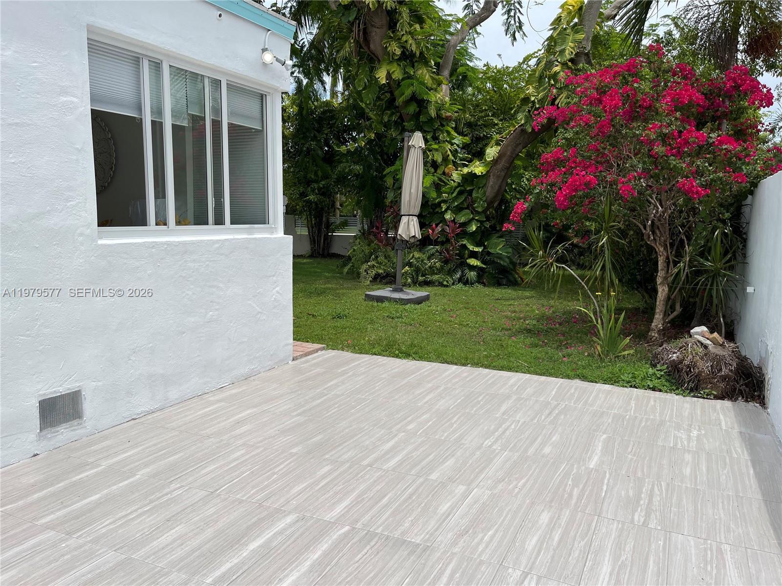 6910 Rue Notre Dame Miami Beach, FL 33141 - Photo 19 of 24 a view of flower garden with a bench