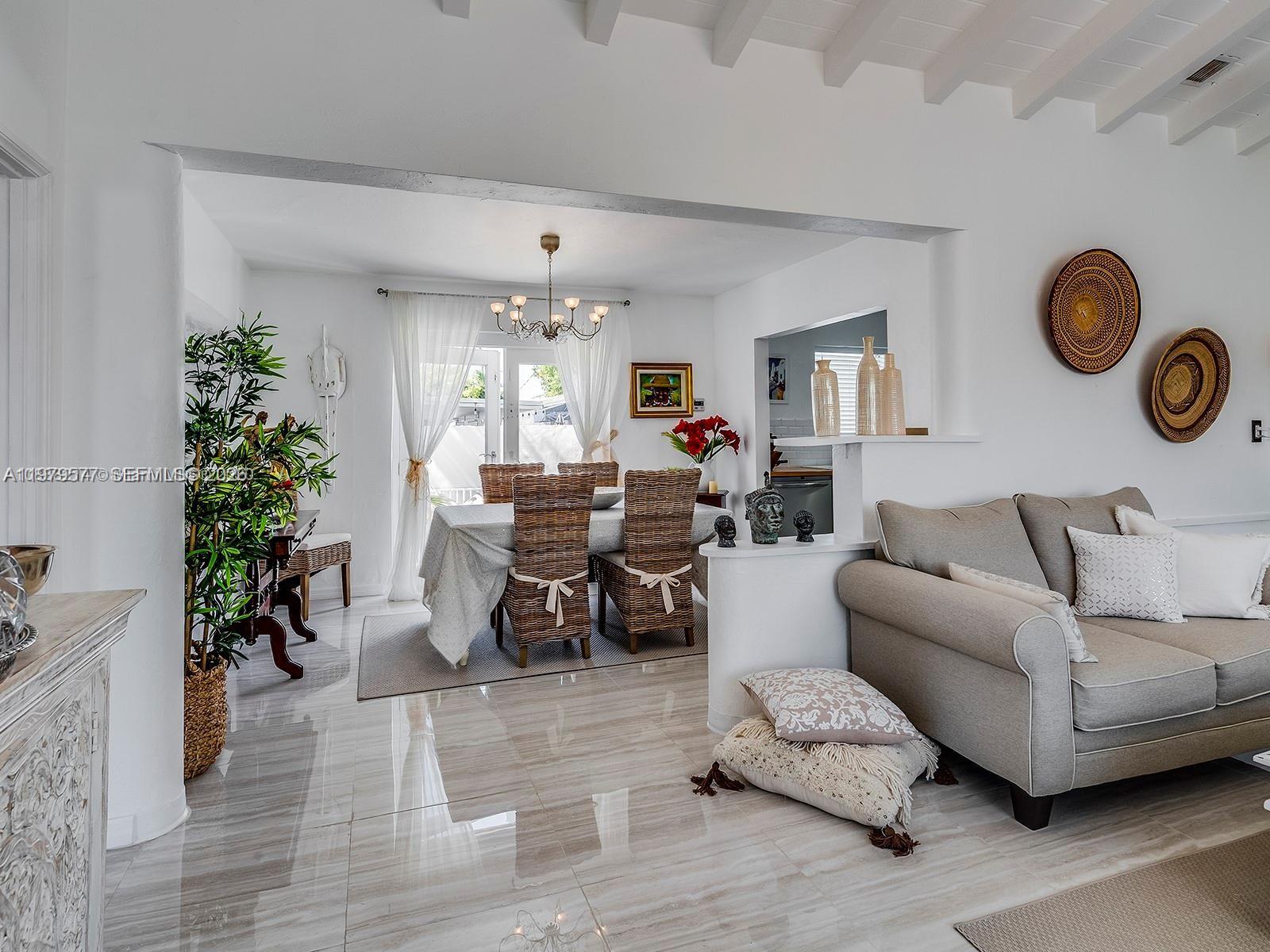 6910 Rue Notre Dame Miami Beach, FL 33141 - Photo 2 of 24 a living room with furniture and a potted plant