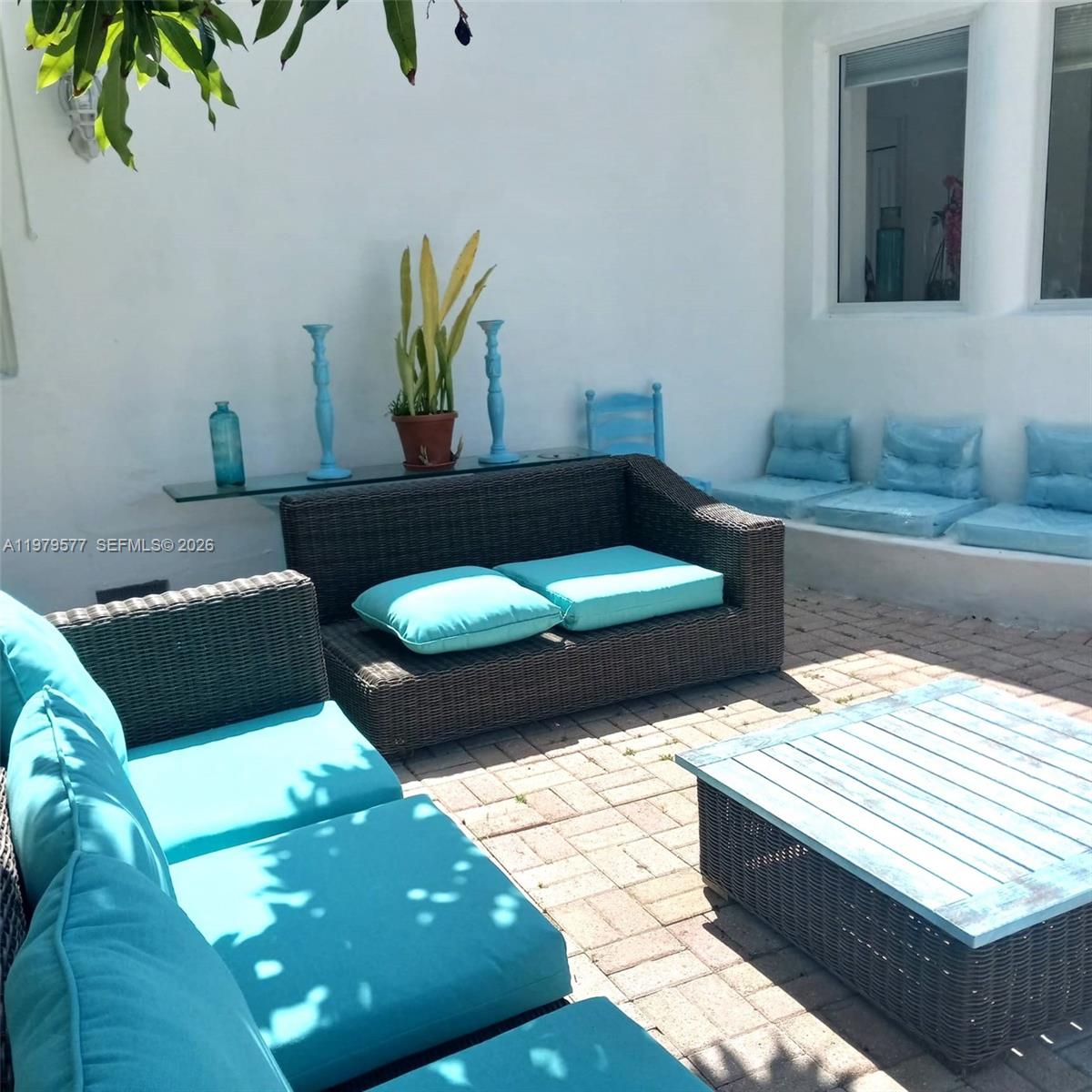 6910 Rue Notre Dame Miami Beach, FL 33141 - Photo 22 of 24 a living room with two couches and a potted plant