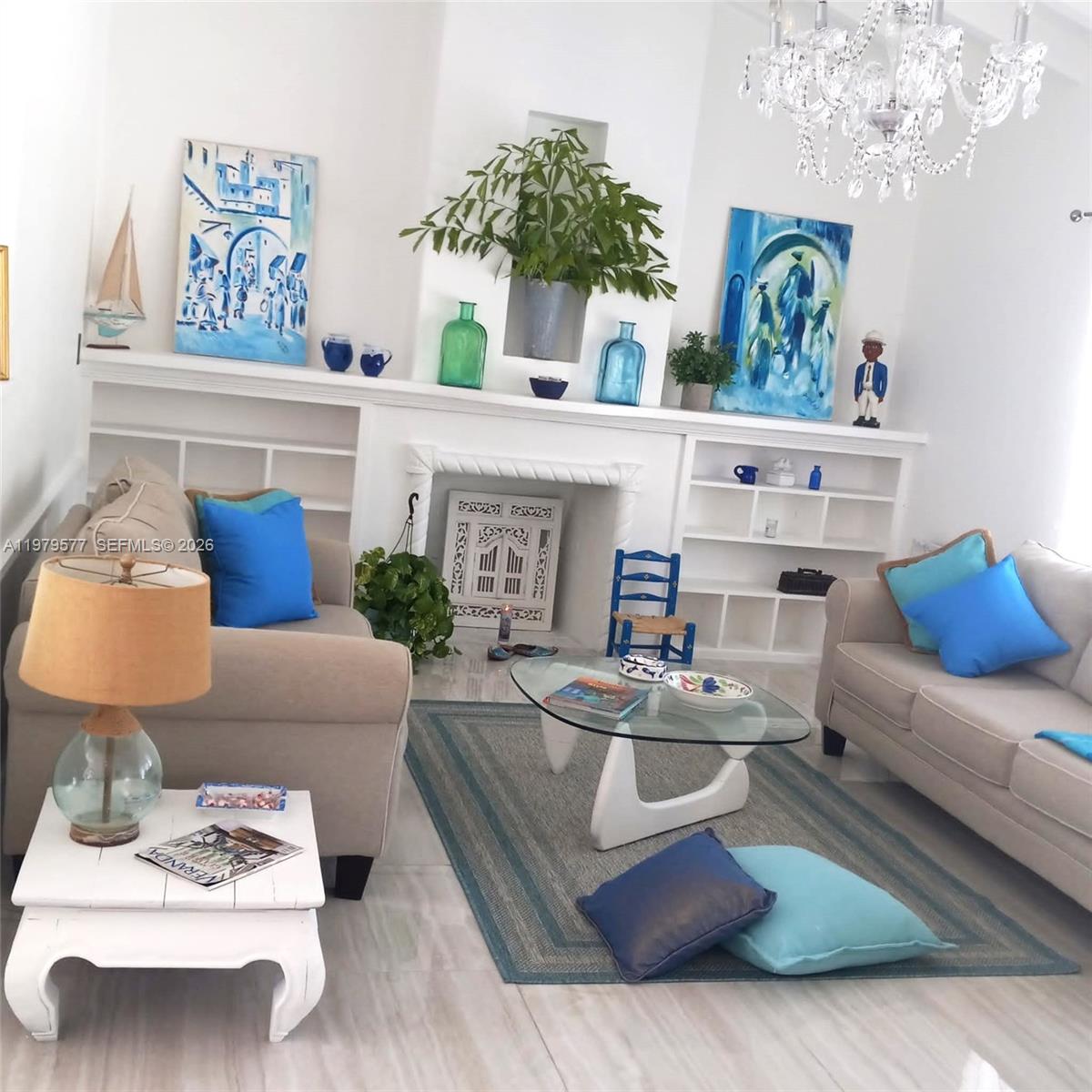 6910 Rue Notre Dame Miami Beach, FL 33141 - Photo 23 of 24 a living room with furniture and a chandelier