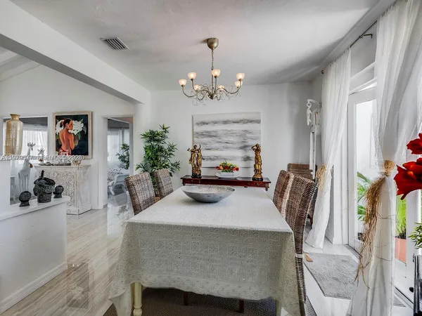 a dining room with furniture and window
