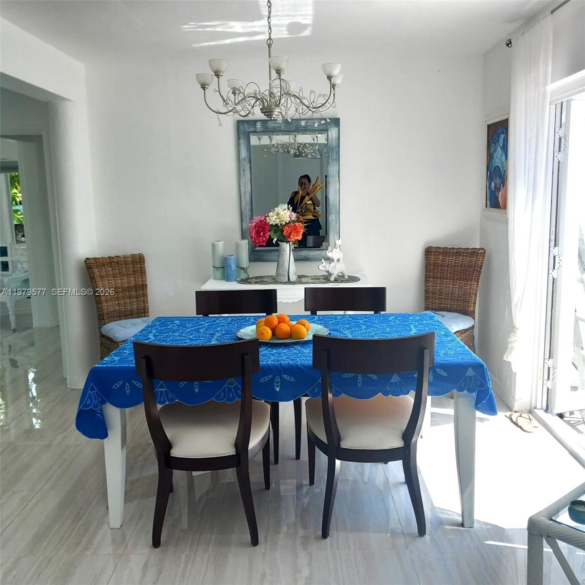 6910 Rue Notre Dame Miami Beach, FL 33141 - Photo 5 of 24 a view of a dining room with furniture and chandelier