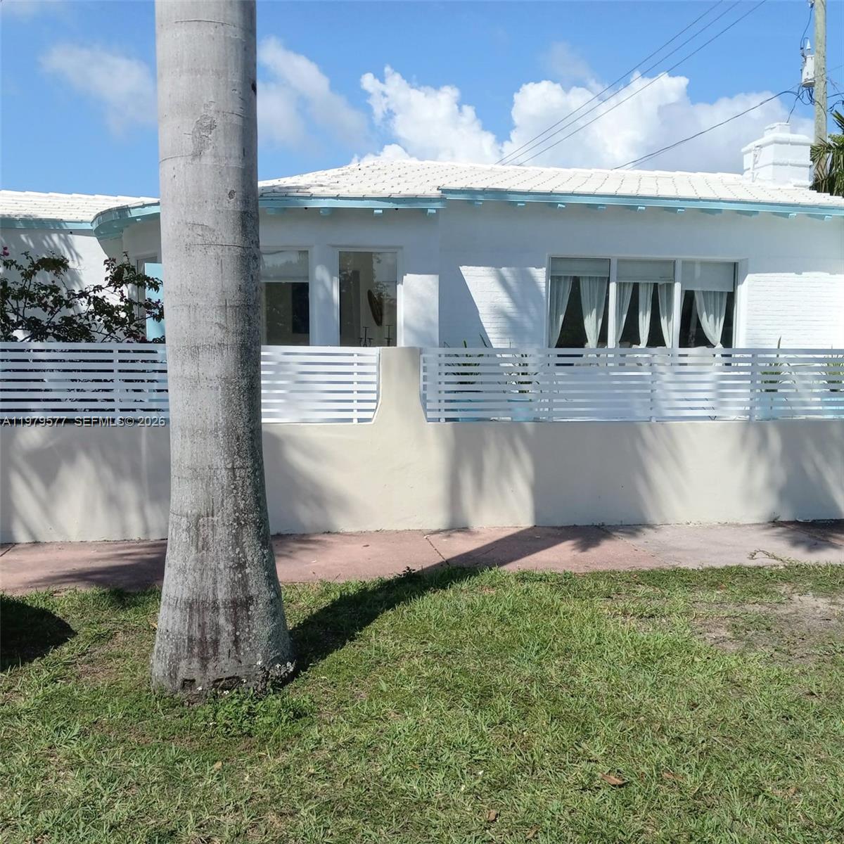 6910 Rue Notre Dame Miami Beach, FL 33141 - Photo 8 of 24 a front view of a house with garden