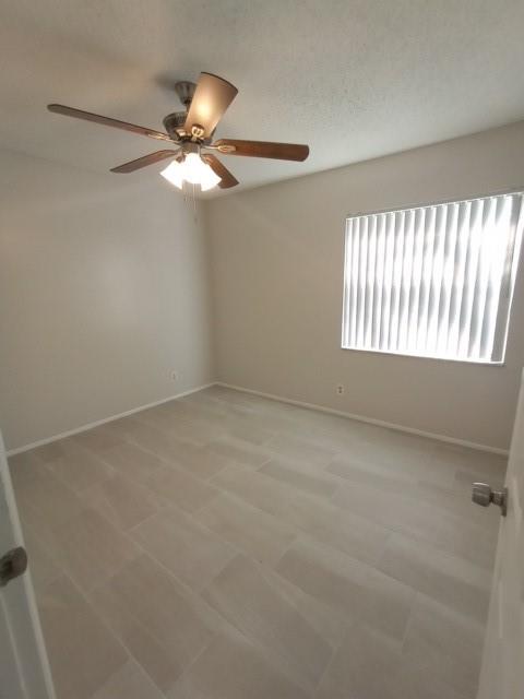 2641 Riverside Drive, Unit 5 Coral Springs, FL 33065 - Photo 15 of 27 an empty room with windows and fan