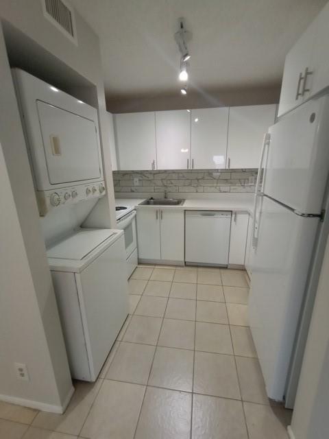 2641 Riverside Drive, Unit 5 Coral Springs, FL 33065 - Photo 23 of 27 a kitchen with a sink a refrigerator and cabinets