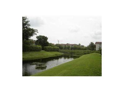 2641 Riverside Drive, Unit 5 Coral Springs, FL 33065 - Photo 27 of 27 a view of a lake with a yard