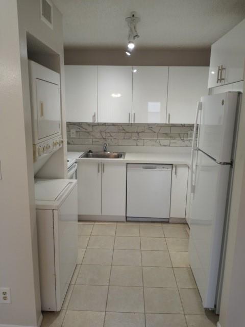2641 Riverside Drive, Unit 5 Coral Springs, FL 33065 - Photo 4 of 27 a kitchen with a sink a refrigerator and cabinets