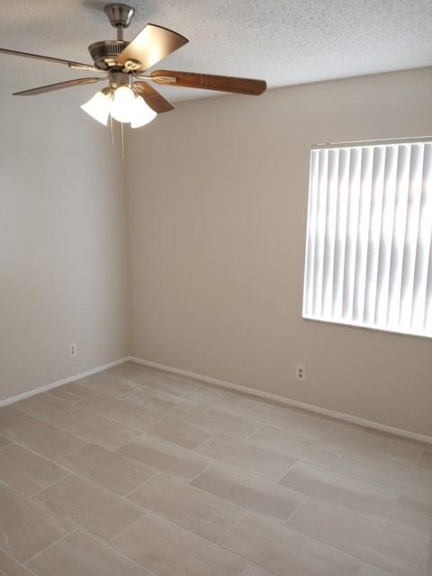 2641 Riverside Drive, Unit 5 Coral Springs, FL 33065 - Photo 6 of 27 en empty room with windows and fan
