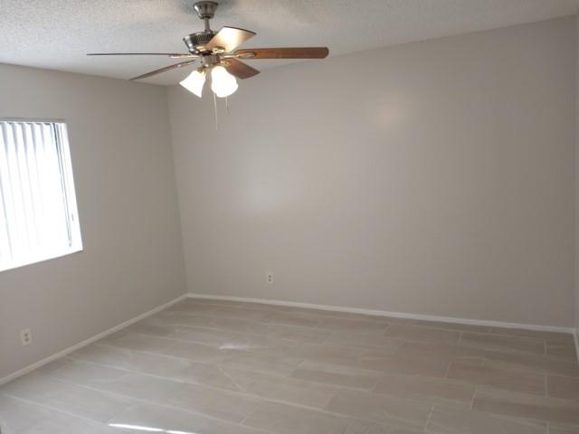 2641 Riverside Drive, Unit 5 Coral Springs, FL 33065 - Photo 7 of 27 an empty room with a window and a fan
