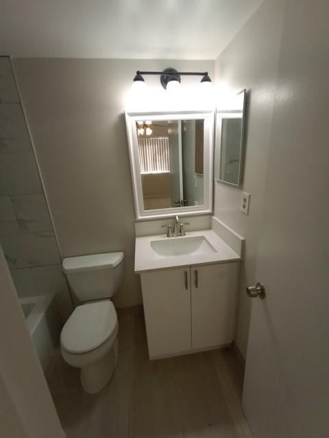2641 Riverside Drive, Unit 5 Coral Springs, FL 33065 - Photo 10 of 27 a bathroom with a sink mirror vanity and toilet