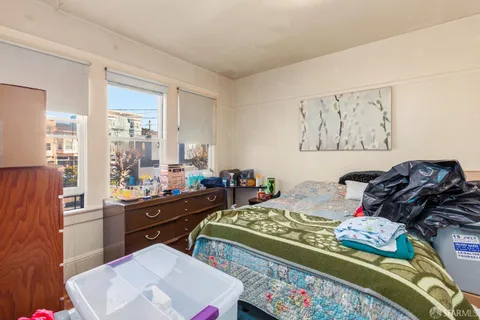 a bed room with a bed and a television