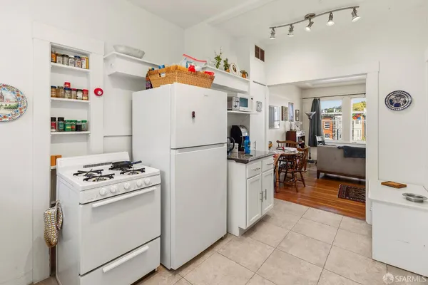 a kitchen with refrigerator and cabinets