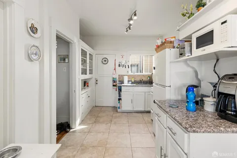 a kitchen with stainless steel appliances granite countertop a refrigerator and a stove