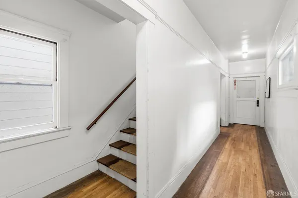 a view of entryway with wooden floor and stairs