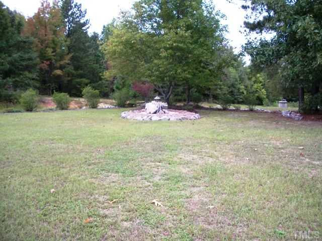 8131 Covered Bridge Road Wendell, NC 27591 - Photo 22 of 22 Back view of the property. Septic system was pumped in 2009. The home is on county water, but does have access to a well for watering the yard. Exterior Back