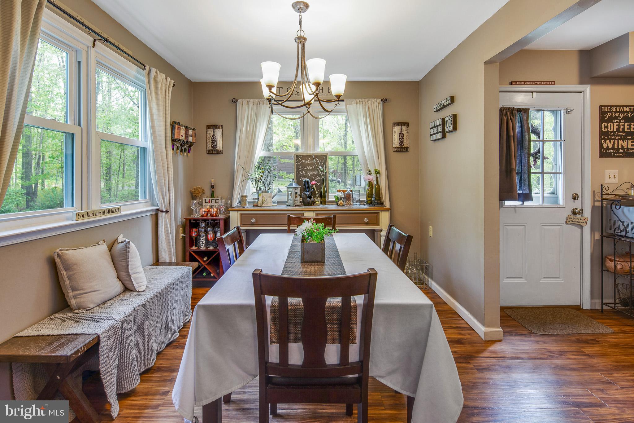 813 Whitehall Road Newfield, NJ 08344 - Photo 8 of 35 Sunfilled Formal Dining Room with Chandelier.
