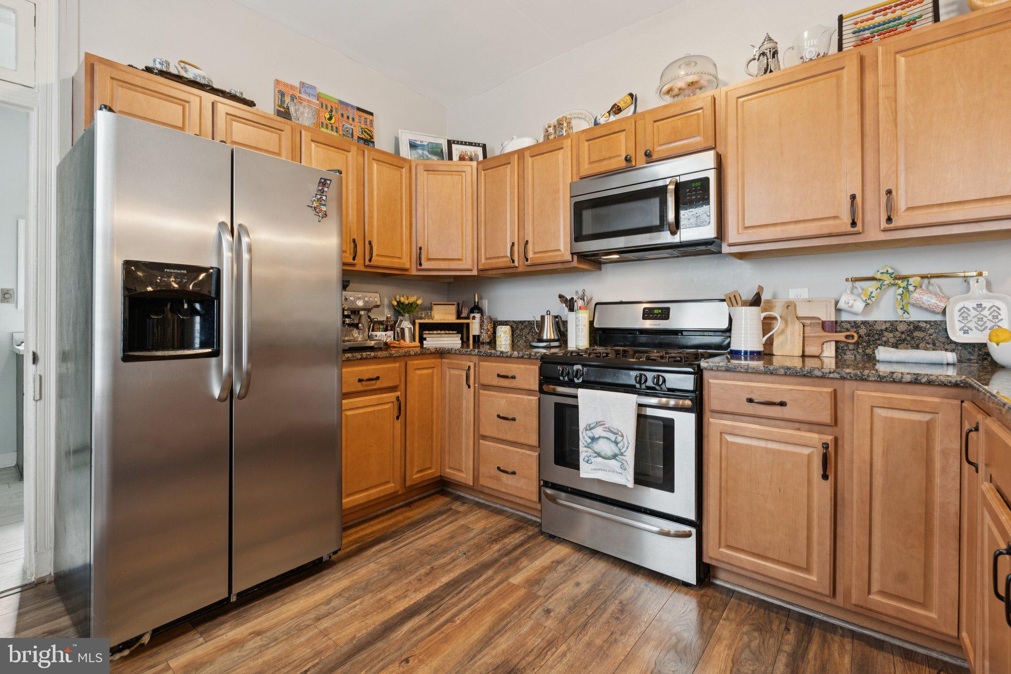 3011 O Donnell Street Baltimore, MD 21224 - Photo 12 of 33 a kitchen with stainless steel appliances and wooden floor