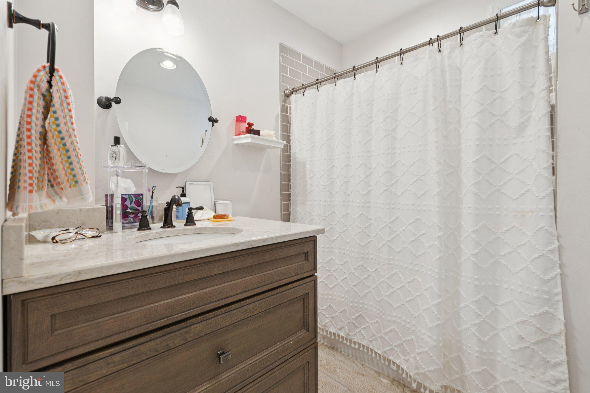 3011 O Donnell Street Baltimore, MD 21224 - Photo 26 of 33 a bathroom with a sink vanity and a mirror