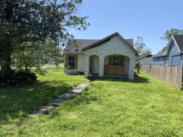 a front view of a house with yard and green space
