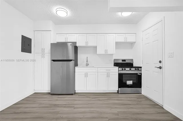 a kitchen with stainless steel appliances a refrigerator stove microwave and cabinets