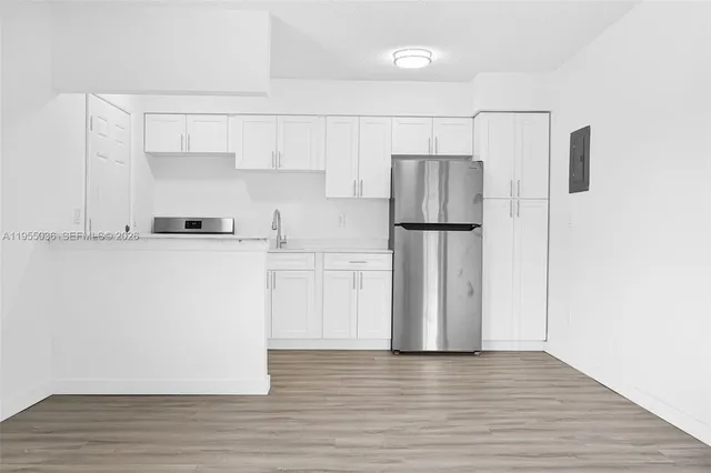a kitchen with stainless steel appliances a refrigerator sink and microwave