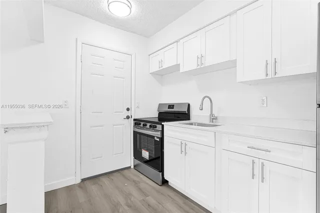 a kitchen with a sink cabinets and appliances
