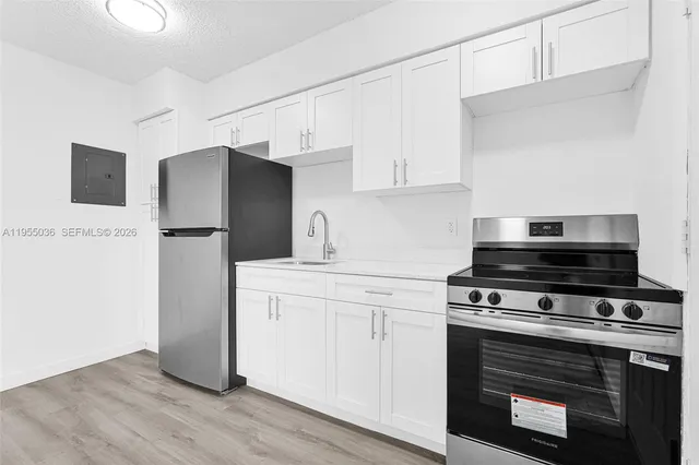 a kitchen with stainless steel appliances a stove a microwave and a refrigerator