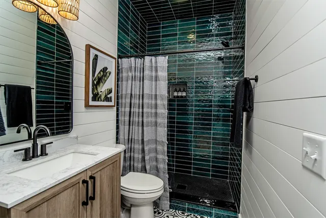 a bathroom with a toilet and a shower