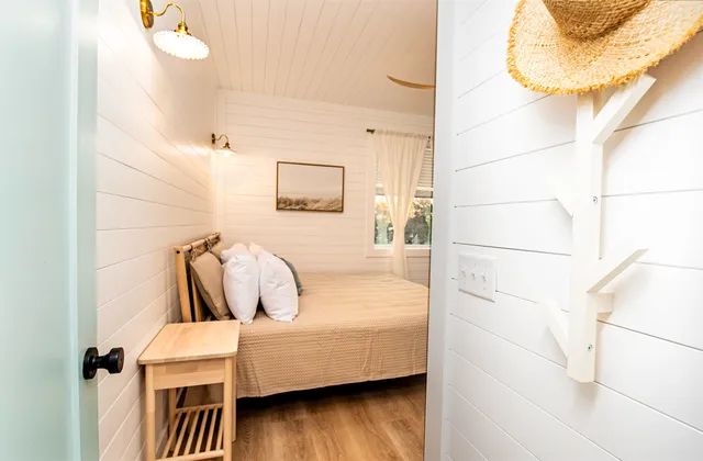 a bedroom with a bed and a large mirror