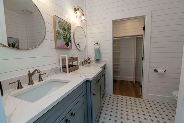 a living room with furniture and a painting on the wall