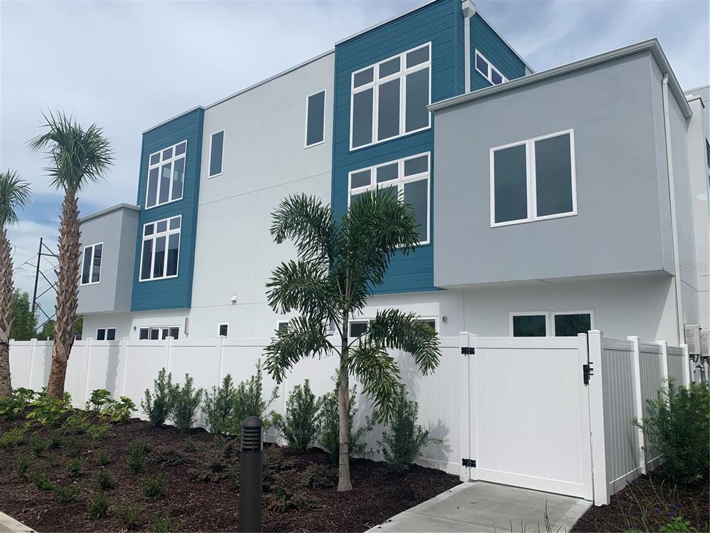 7770 Sandy Ridge Drive, Unit 210 Reunion, FL 34747 - Photo 2 of 42 a view of building with potted plants