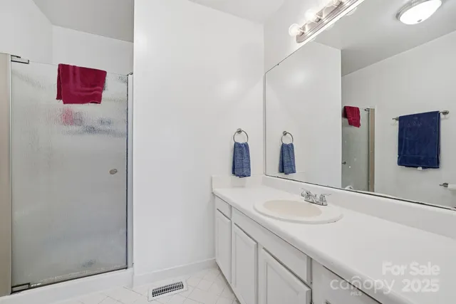 a bathroom with a sink vanity and mirror