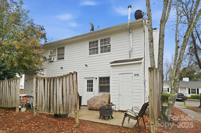 a view of a house with a backyard and a tree